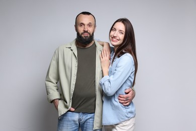 Photo of Portrait of happy daughter and father on light grey background