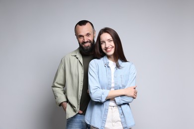 Photo of Portrait of happy daughter and father on light grey background