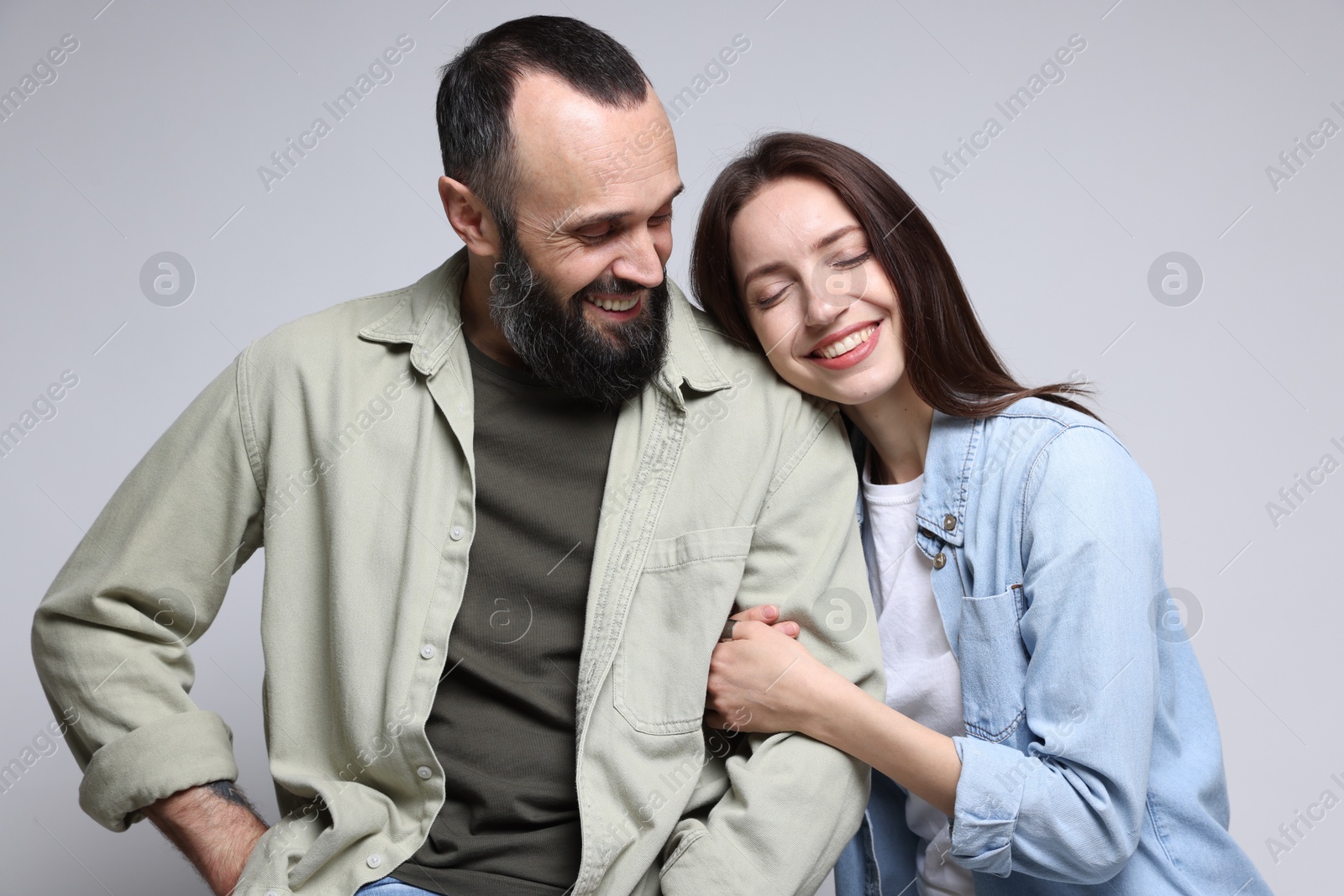 Photo of Happy daughter and father on light grey background