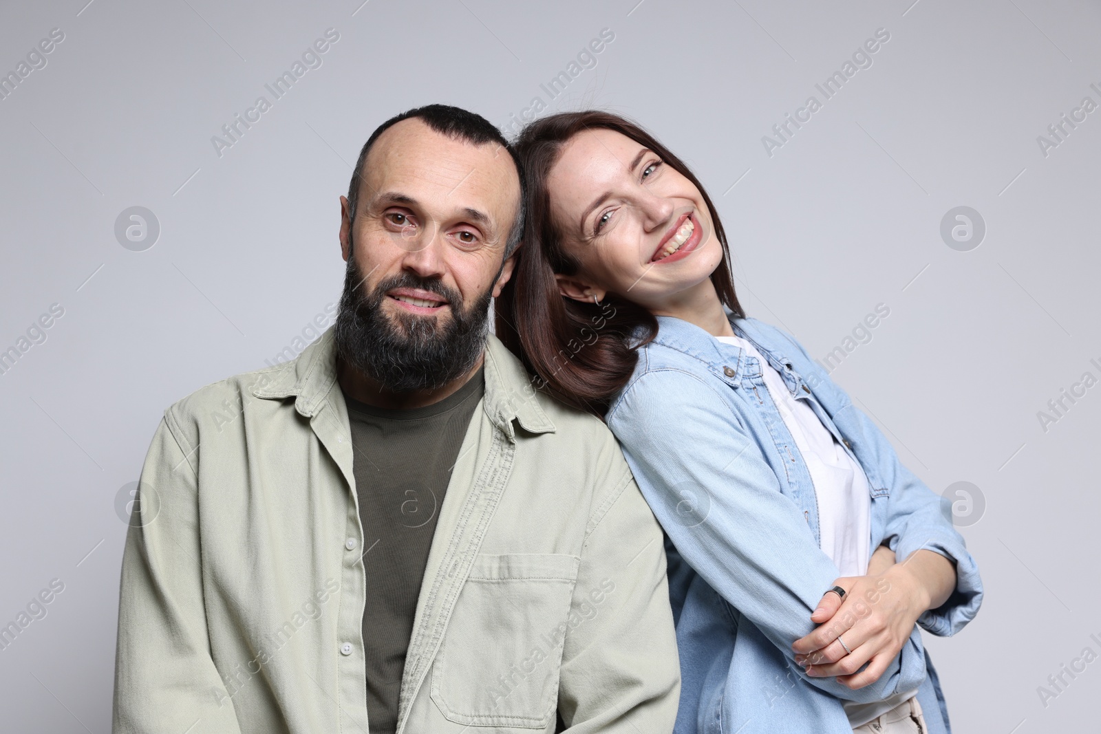 Photo of Portrait of happy daughter and father on light grey background