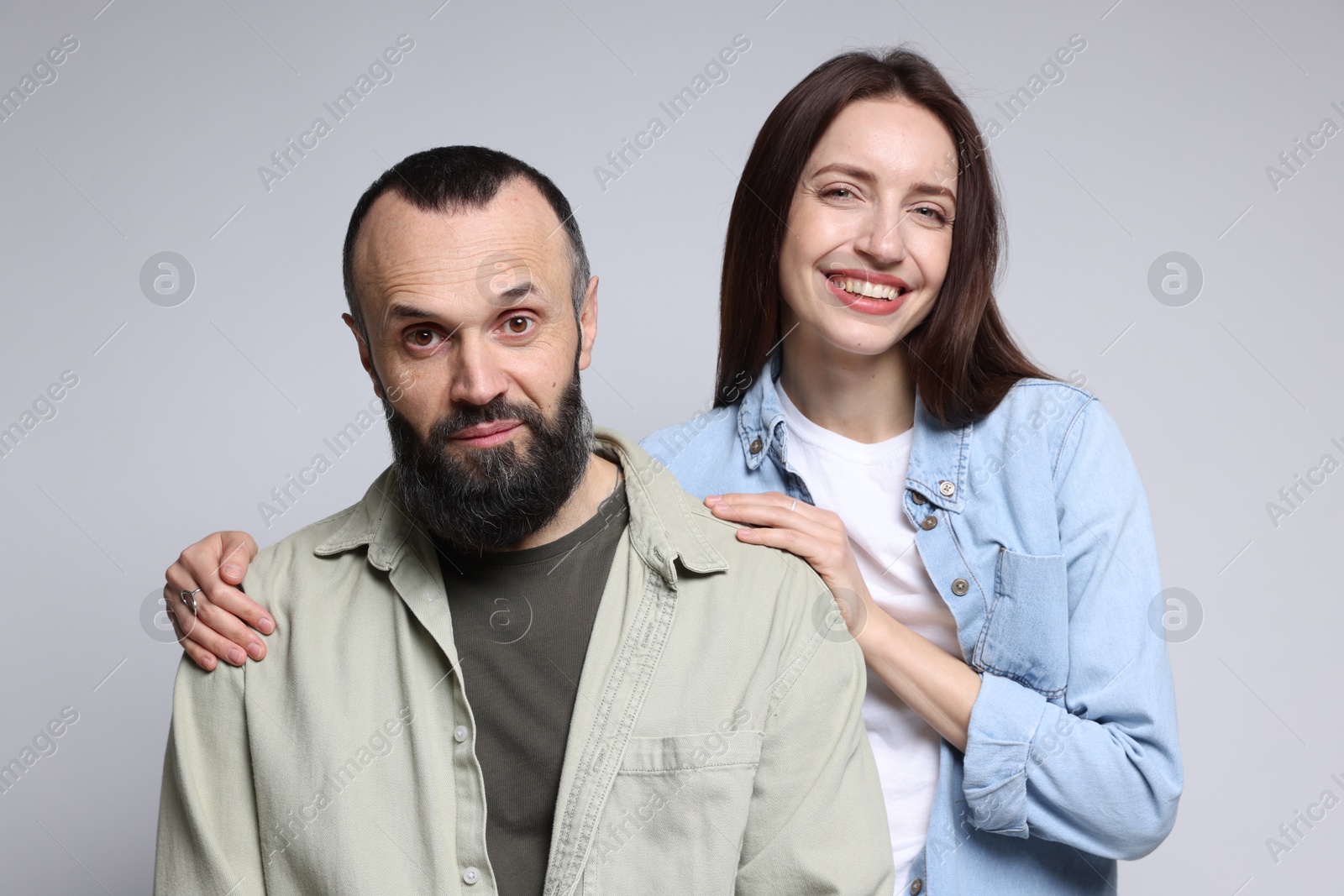 Photo of Portrait of happy daughter and father on light grey background