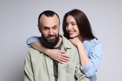 Photo of Happy daughter and father on light grey background