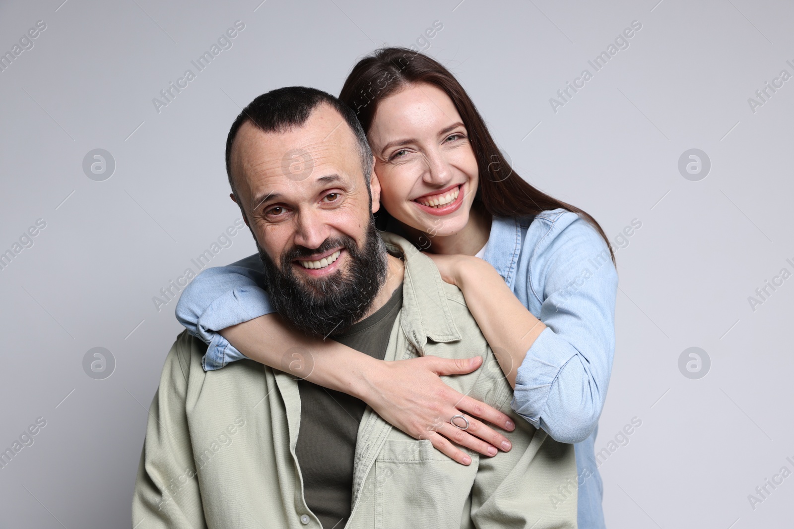 Photo of Portrait of happy daughter and father on light grey background