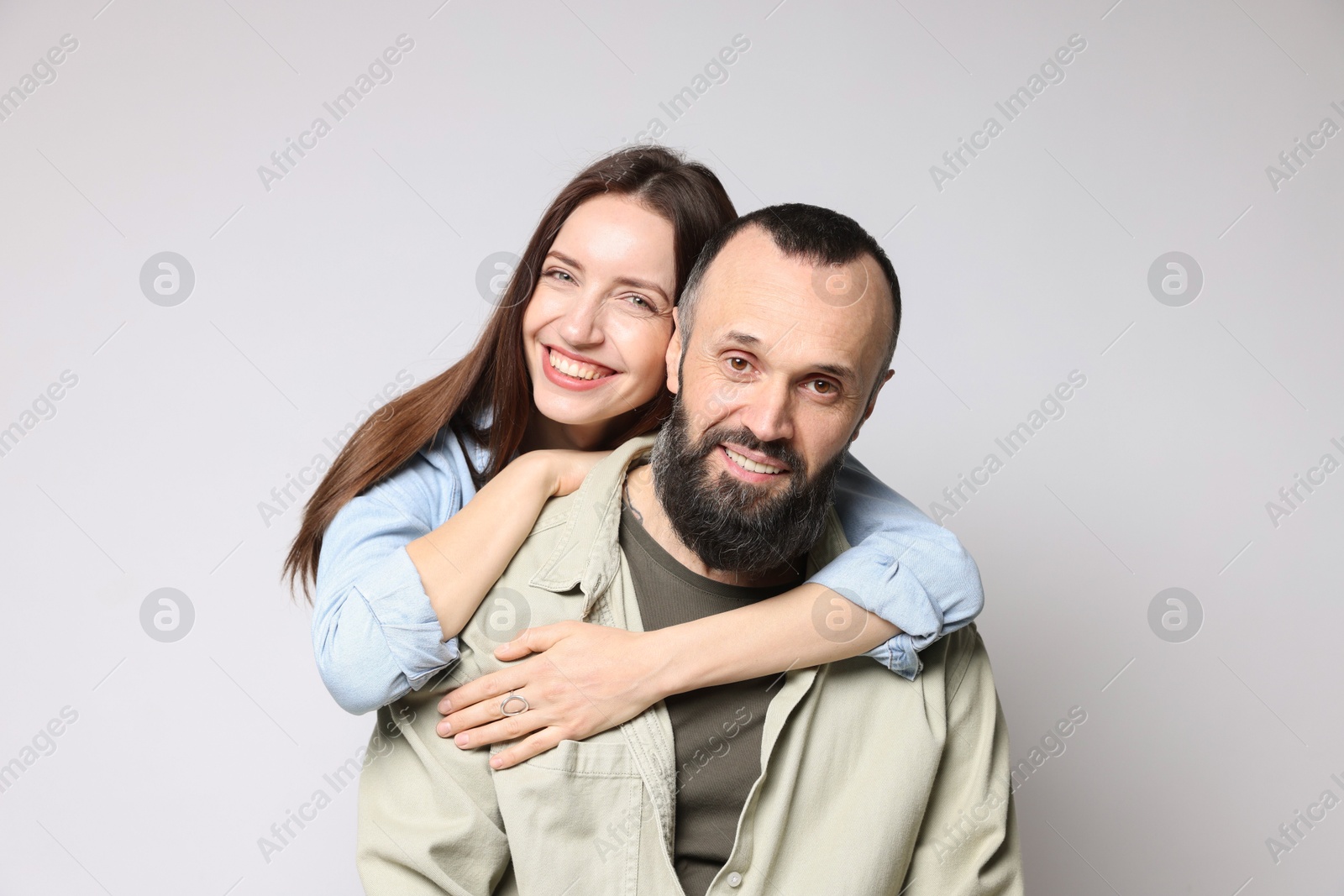 Photo of Portrait of happy daughter and father on light grey background