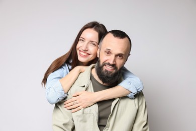 Photo of Portrait of happy daughter and father on light grey background