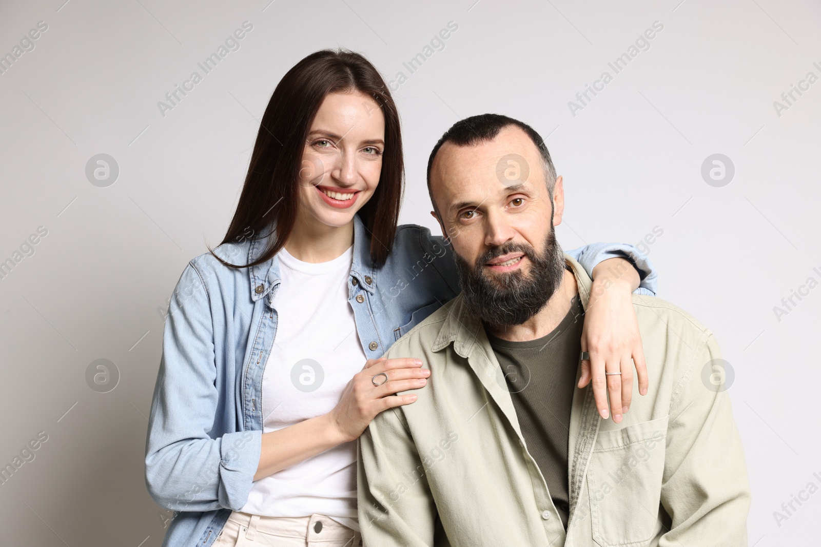 Photo of Portrait of happy daughter and father on light grey background