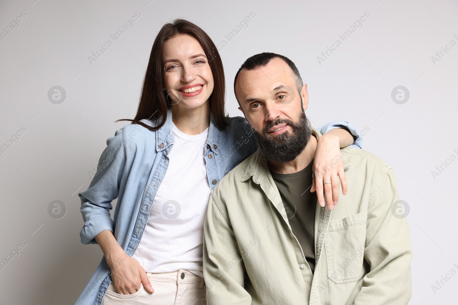 Photo of Portrait of happy daughter and father on light grey background