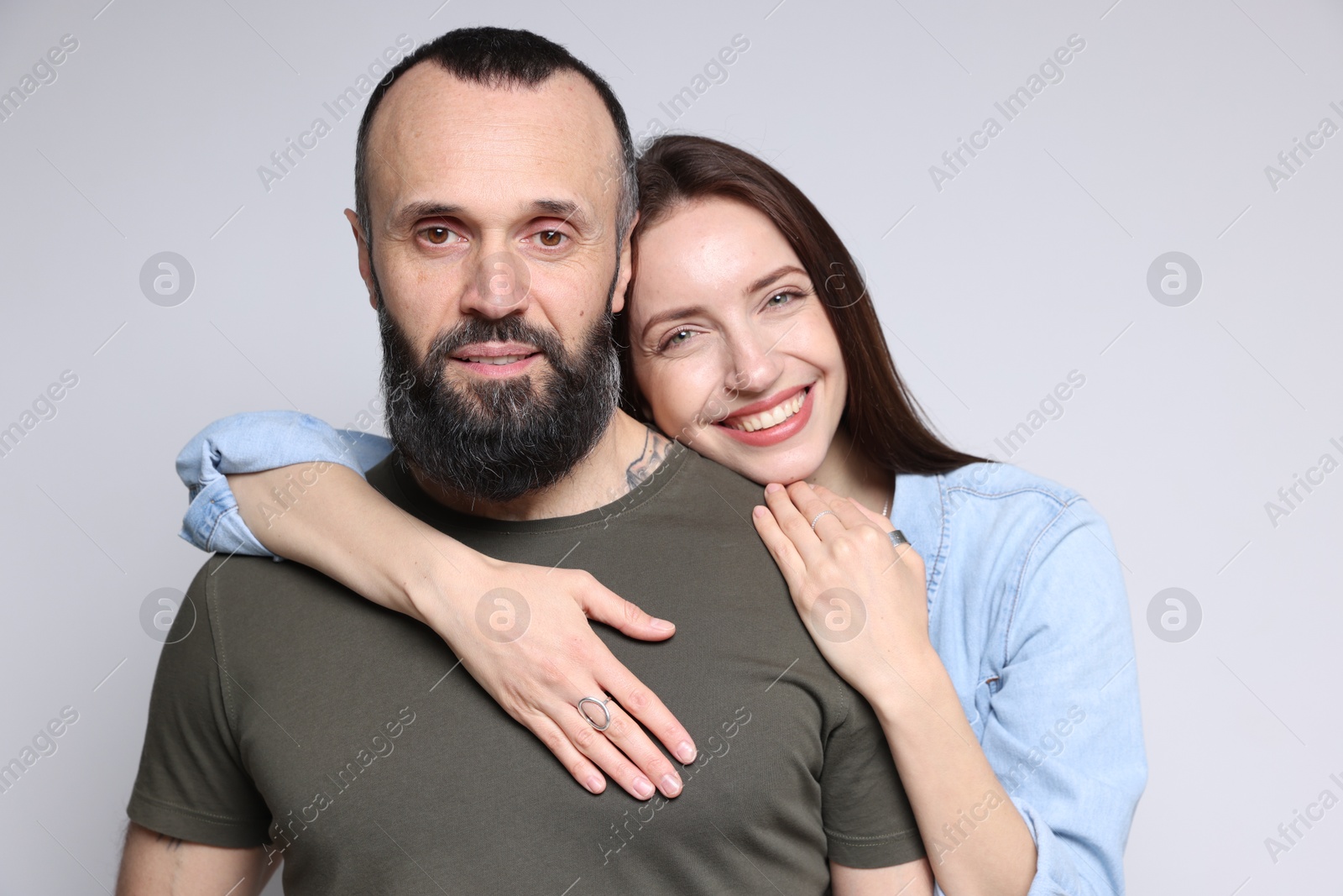 Photo of Portrait of happy daughter and father on light grey background