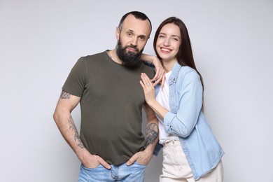 Photo of Portrait of happy daughter and father on light grey background