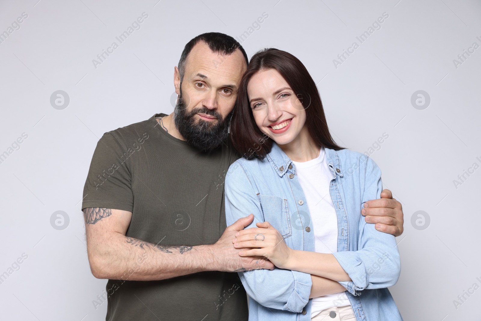 Photo of Portrait of happy daughter and father on light grey background