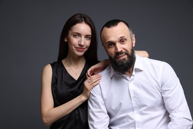 Photo of Portrait of happy daughter and father on dark grey background