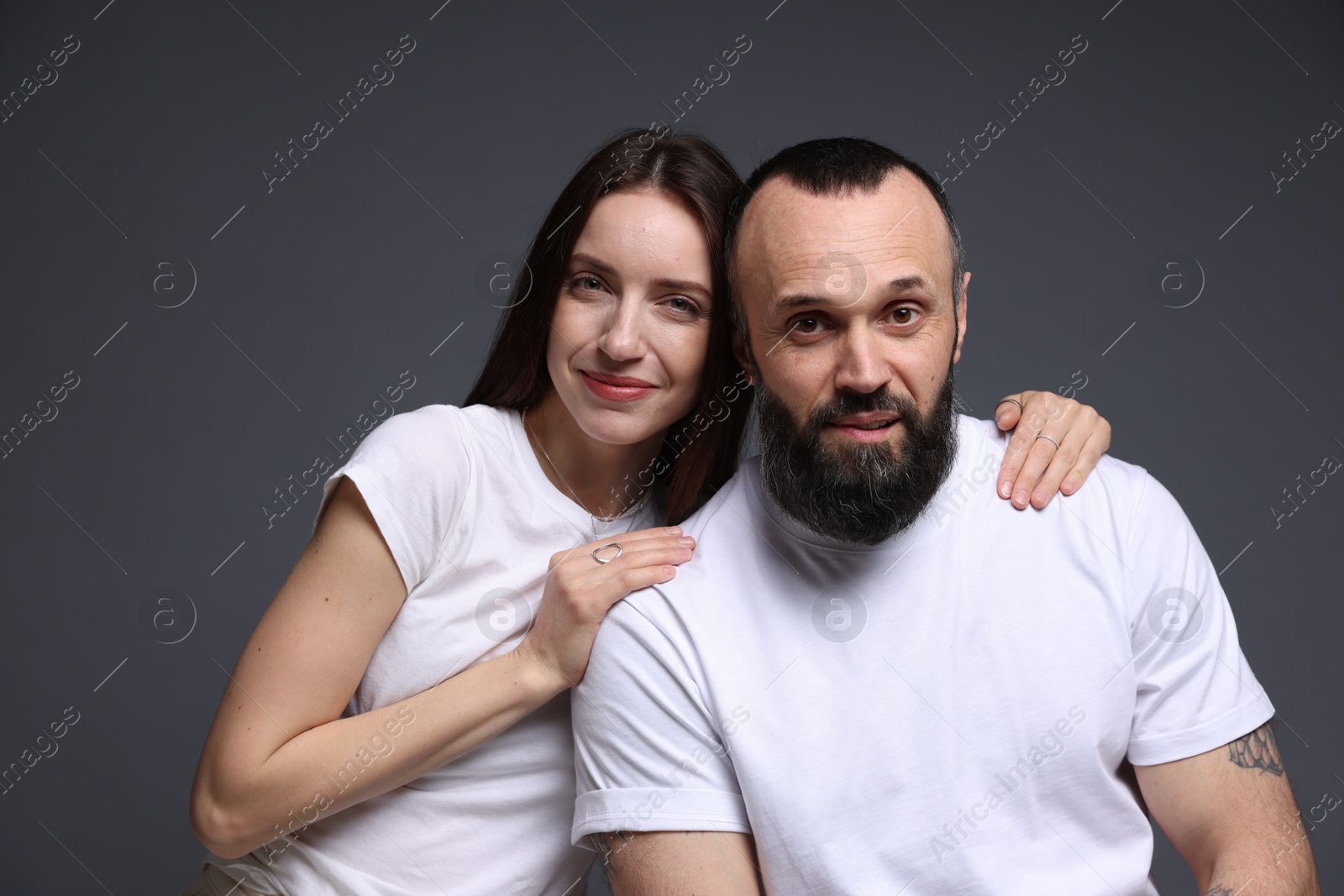 Photo of Portrait of happy daughter and father on dark grey background