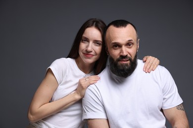 Photo of Portrait of happy daughter and father on dark grey background