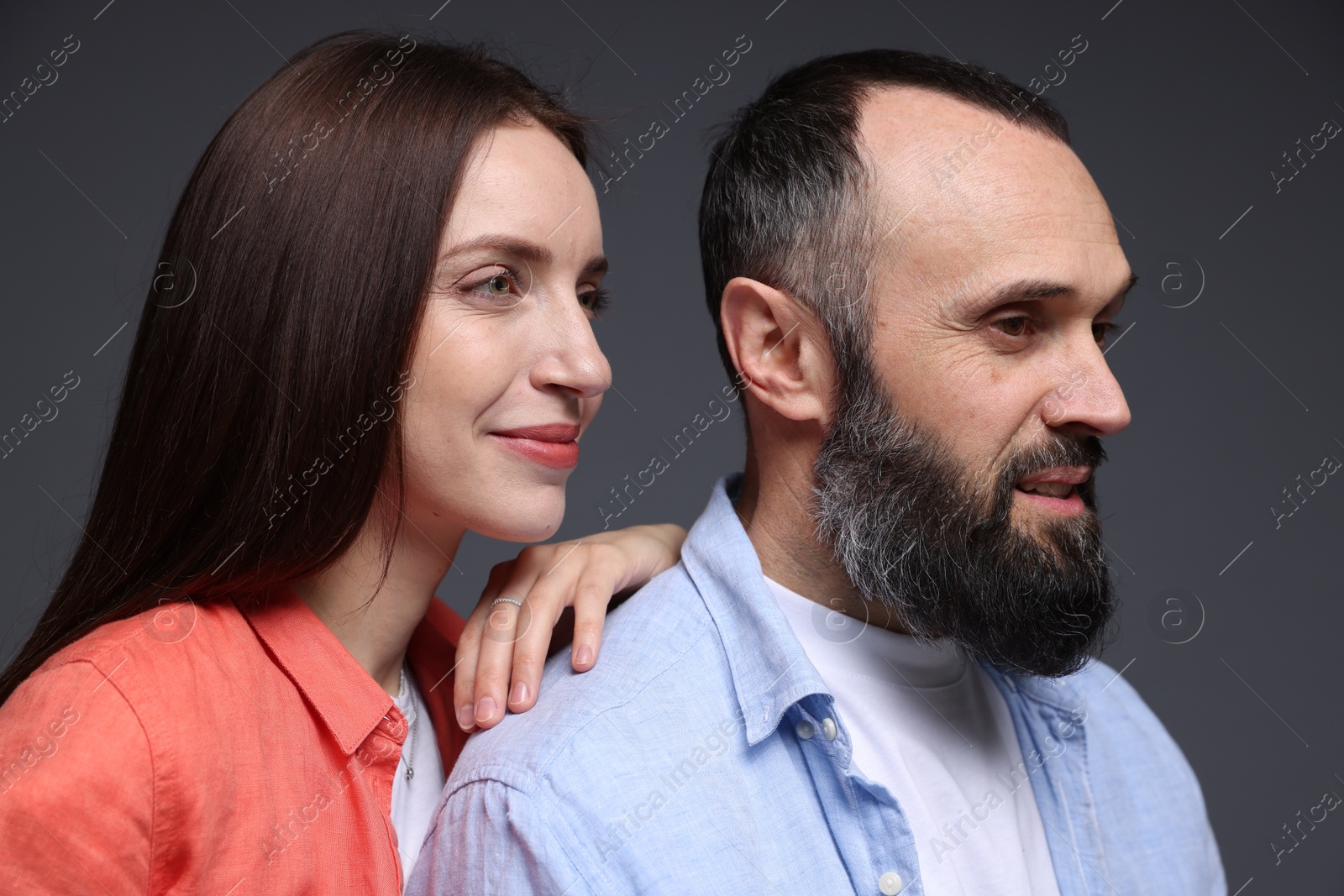 Photo of Happy daughter and father on dark grey background