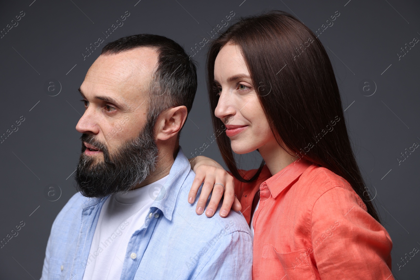 Photo of Happy daughter and father on dark grey background