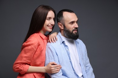 Photo of Happy daughter and father on dark grey background