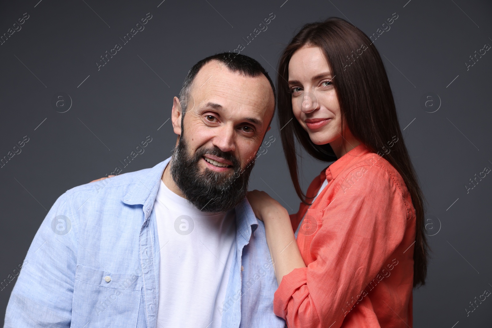 Photo of Portrait of happy daughter and father on dark grey background