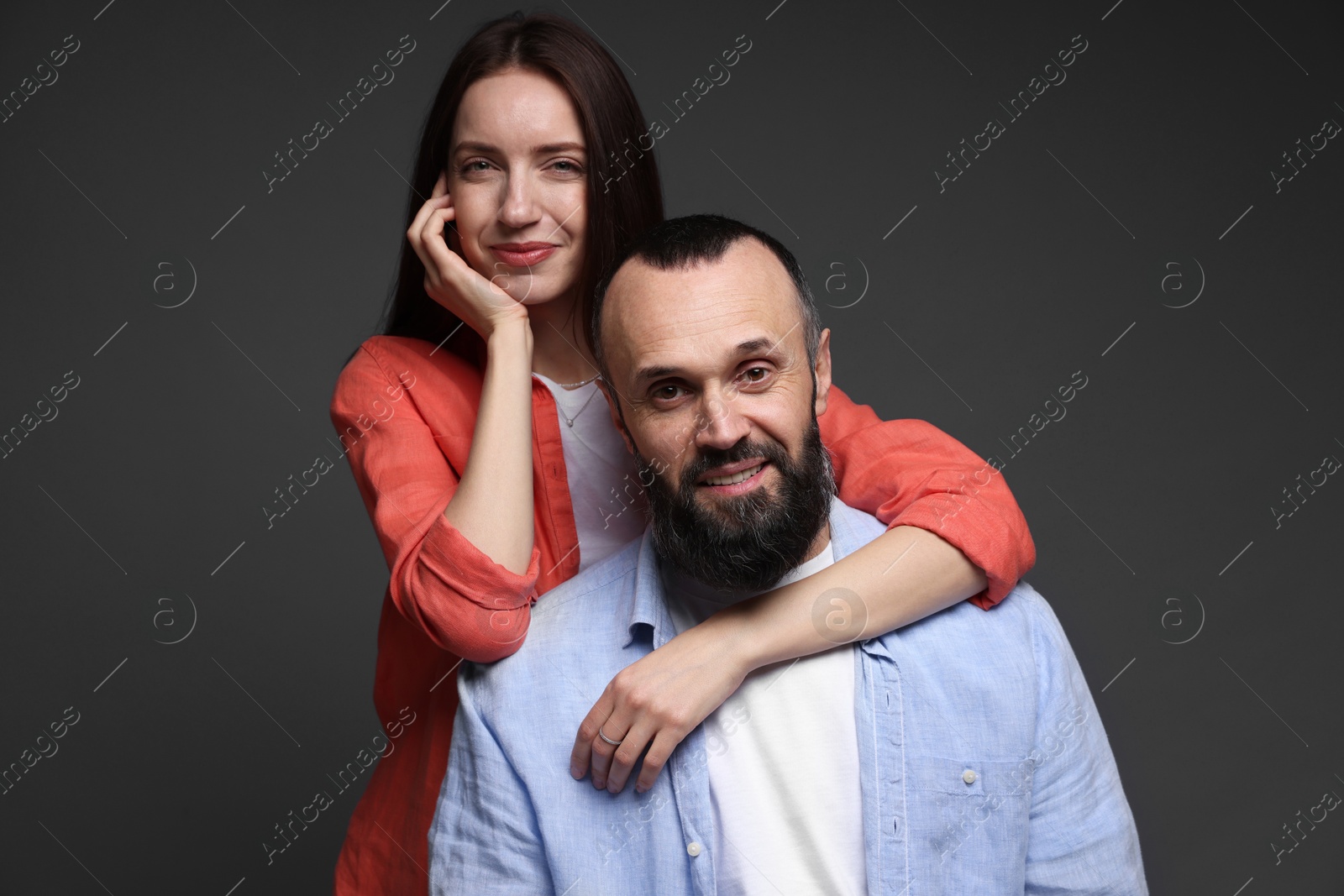 Photo of Portrait of happy daughter and father on dark grey background