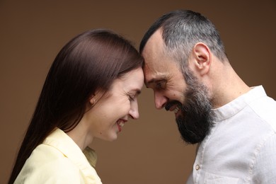 Photo of Happy daughter and father on brown background