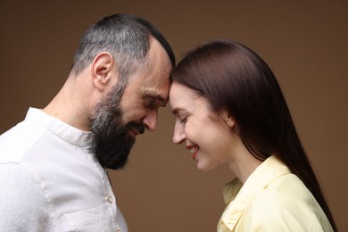 Photo of Happy daughter and father on brown background