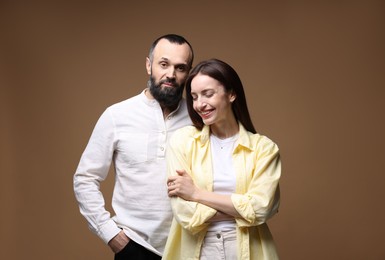 Photo of Happy daughter and father on brown background