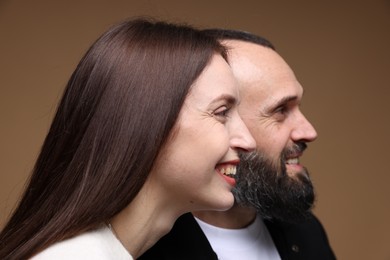 Photo of Happy daughter and father on brown background