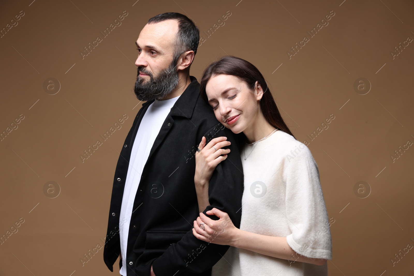 Photo of Cute daughter and father on brown background