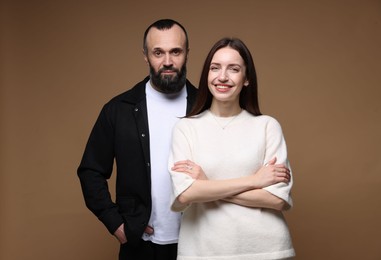 Photo of Portrait of happy daughter and father on brown background