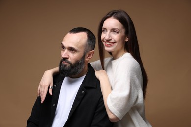 Photo of Happy daughter and father on brown background