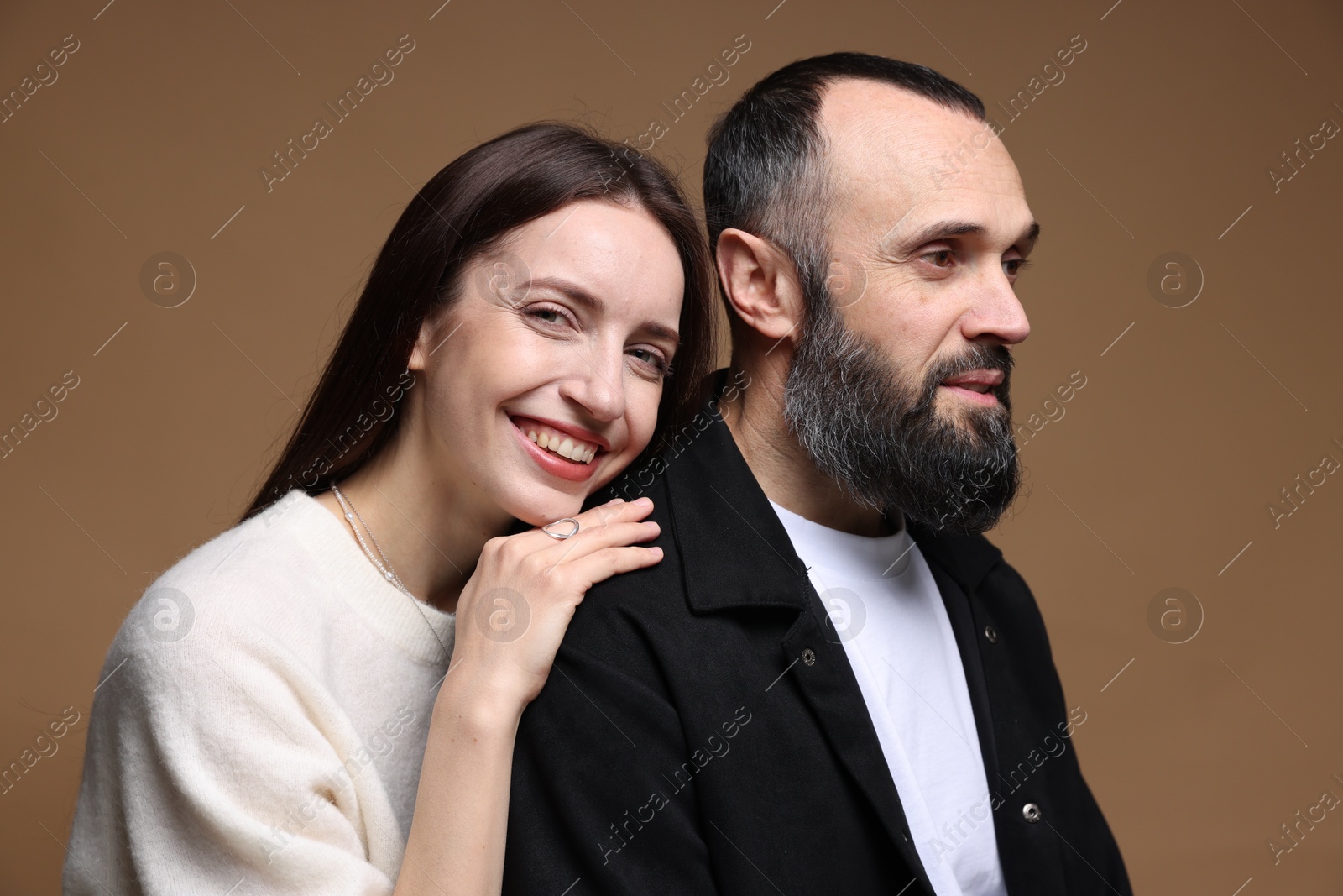 Photo of Happy daughter and father on brown background