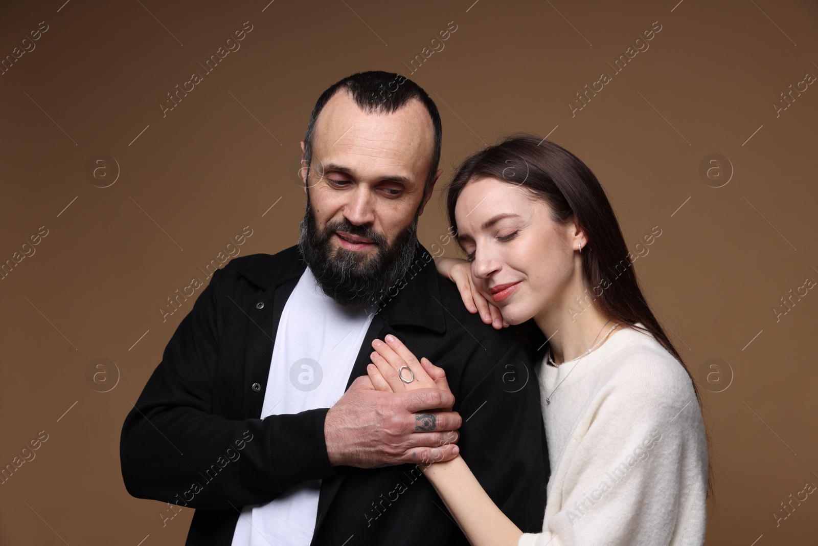 Photo of Cute daughter and father on brown background