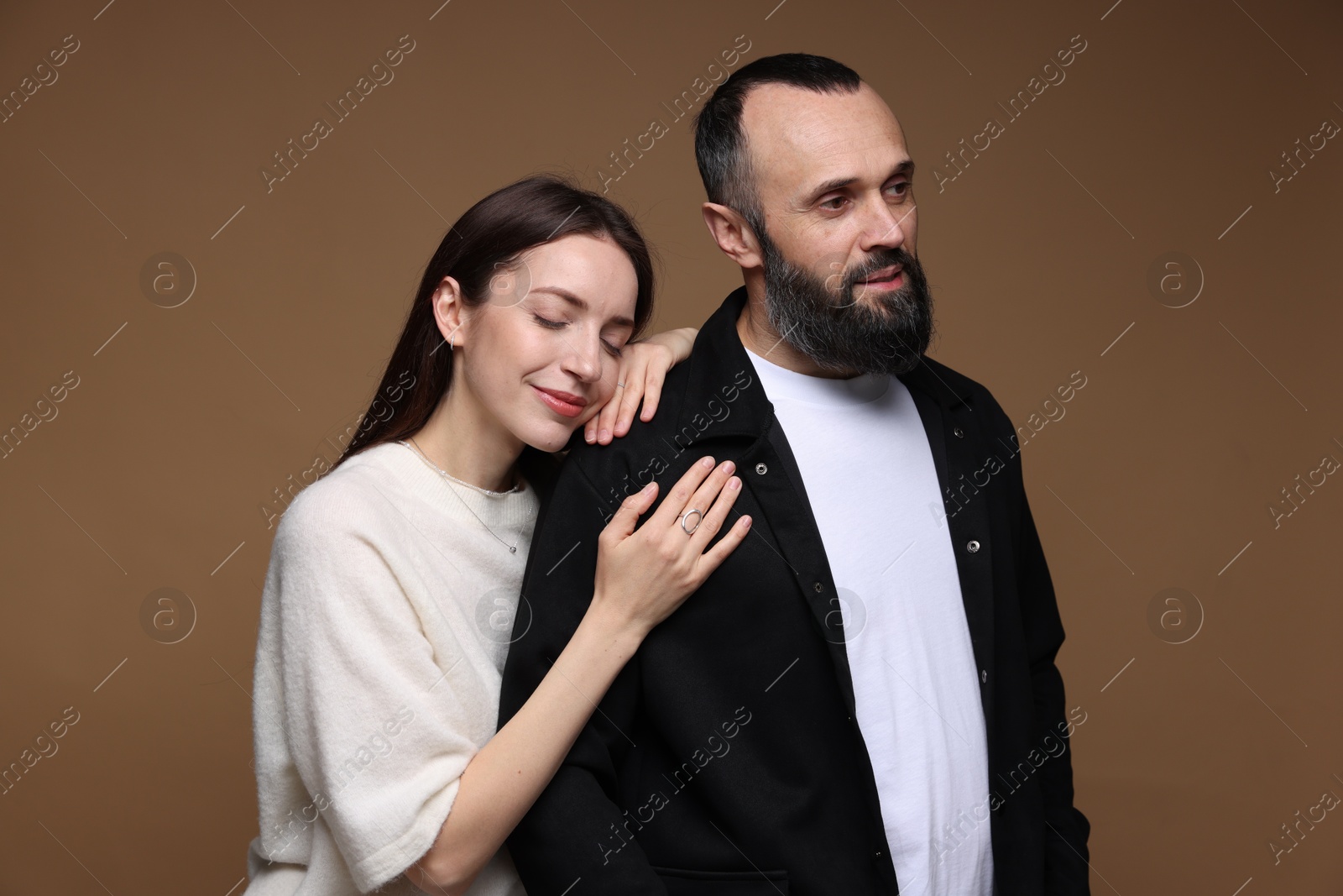 Photo of Cute daughter and father on brown background