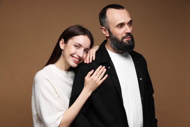 Photo of Happy daughter and father on brown background