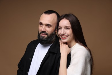 Photo of Happy daughter and father on brown background