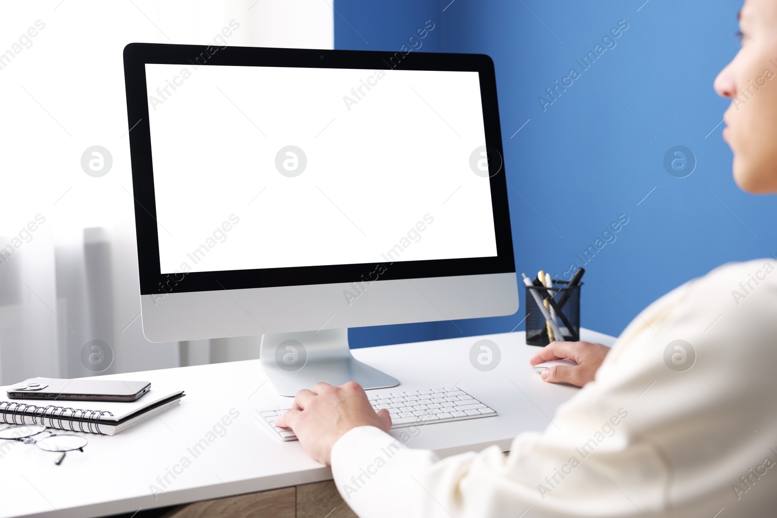 Photo of Man working on computer at white desk in office, closeup. Mockup for design