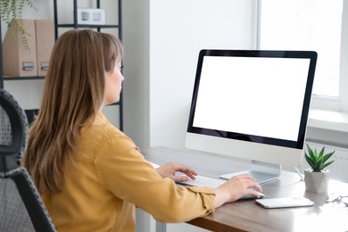 Woman working on computer at wooden desk in office. Mockup for design