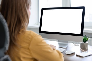 Woman working on computer at desk in office. Mockup for design