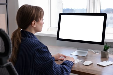 Woman working on computer at wooden desk in office. Mockup for design