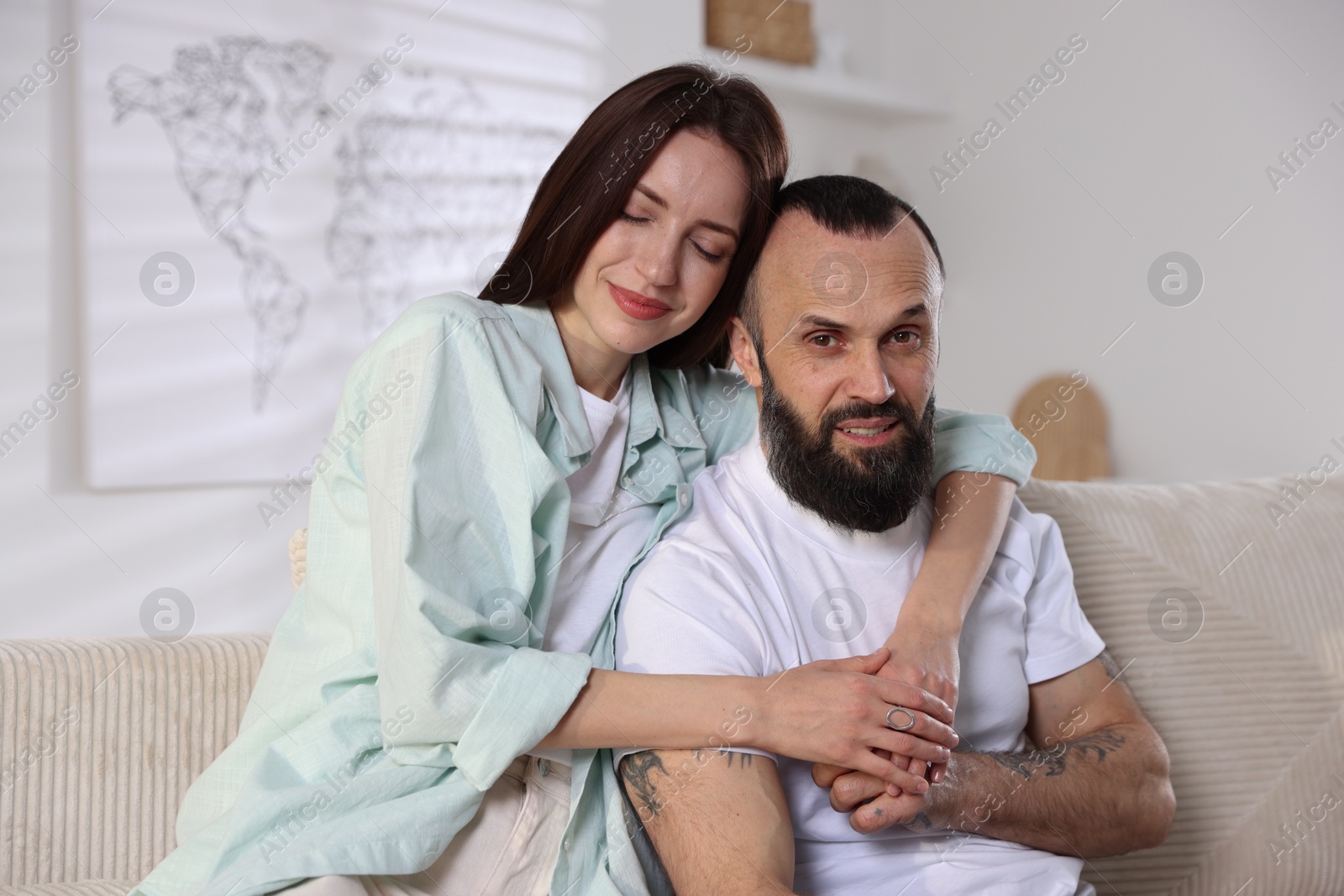 Photo of Happy daughter and father on sofa at home