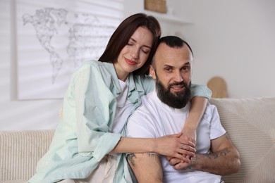 Photo of Happy daughter and father on sofa at home