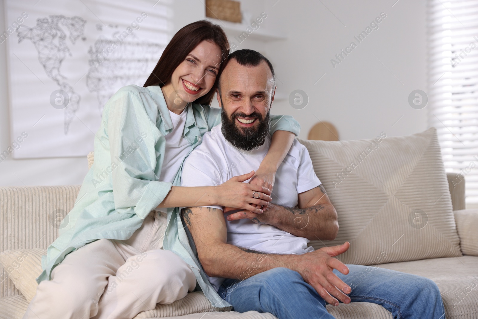 Photo of Portrait of happy daughter and father on sofa at home