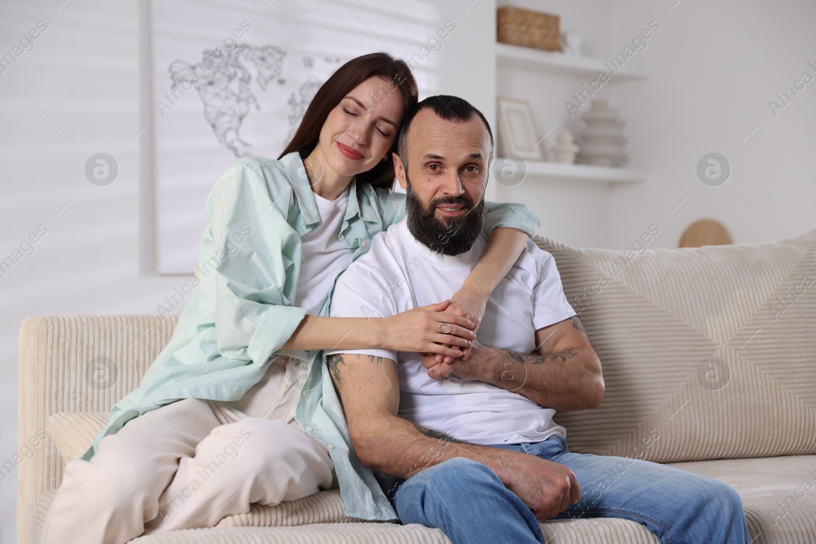 Photo of Happy daughter and father on sofa at home