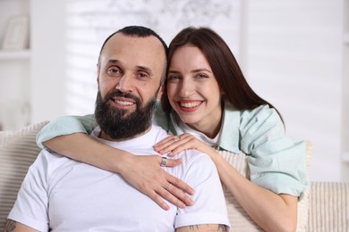 Photo of Portrait of happy daughter and father on sofa at home