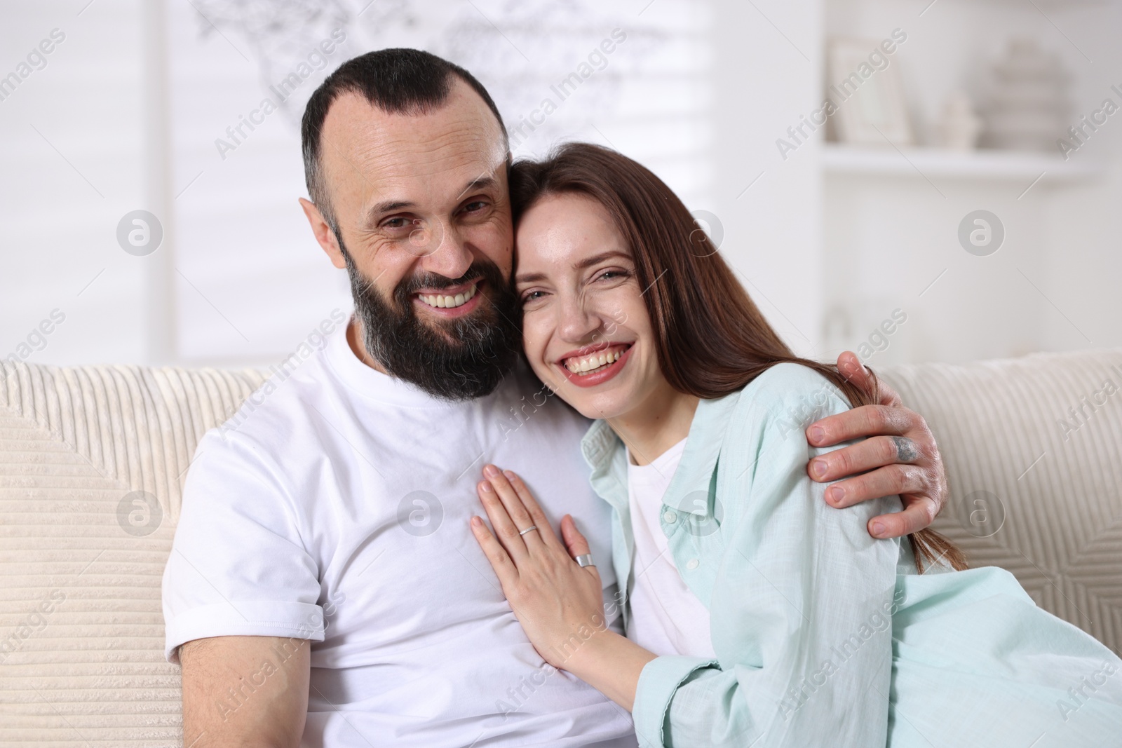 Photo of Portrait of happy daughter and father on sofa at home