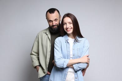 Photo of Portrait of happy daughter and father on light grey background