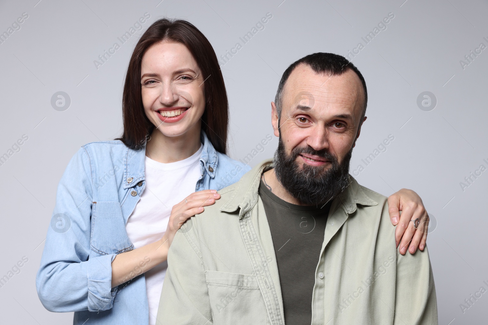 Photo of Portrait of happy daughter and father on light grey background