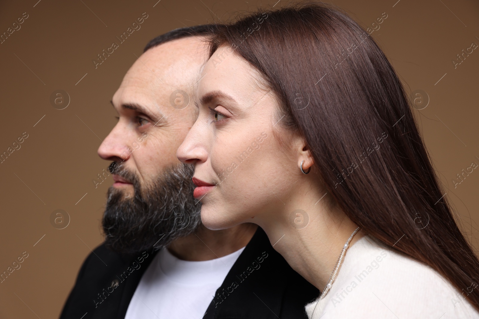 Photo of Cute daughter and father on brown background