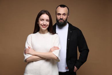 Photo of Portrait of happy daughter and father on brown background