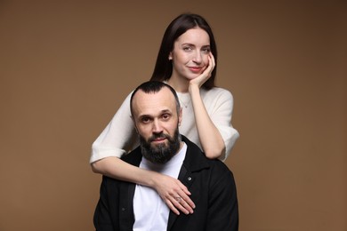 Photo of Portrait of daughter and father on brown background