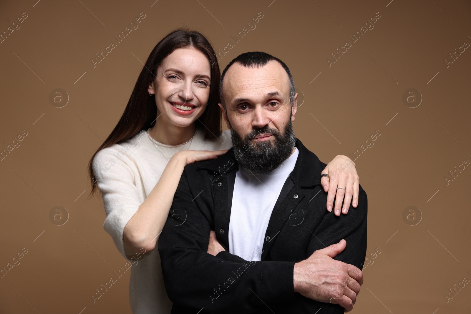 Photo of Portrait of happy daughter and father on brown background